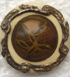 Celluloid Glow center with pastes set into brass border
